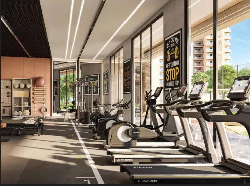 Indoor gymnasium with cardio and strength equipment at Ashiana Aaroham