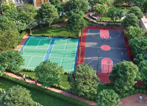 Tennis and basketball courts surrounded by landscaped gardens at Ashiana Aaroham